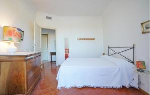 a bedroom with a white bed and a dresser at Nice Home In Ventimiglia in Ventimiglia