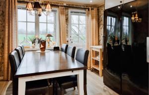 a dining room table with chairs and a television at 4 Bedroom Pet Friendly Home In Upplid in Upplid
