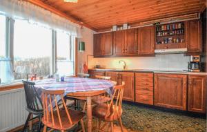 a kitchen with a table and some chairs and a window at Lovely Home In Fengersfors With Wifi in Fengersfors