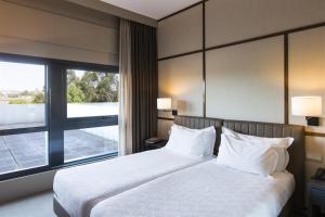 Postel nebo postele na pokoji v ubytování Hotel de Guimaraes Business & SPA
