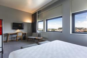 Postel nebo postele na pokoji v ubytování Hotel de Guimaraes Business & SPA