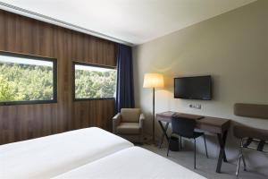 TV a/nebo společenská místnost v ubytování Hotel de Guimaraes Business & SPA