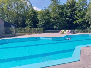 a swimming pool with blue water in a yard at Beautiful Villa close to beaches in Sint Maarten