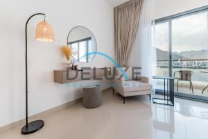 a rendering of a living room with a table and a mirror at Special Rate with Temp Controlled Pool, BBQ & Maid's by Deluxe Holiday Homes in Fujairah
