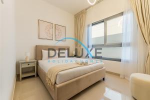 a bedroom with a bed and a window at Special Rate with Temp Controlled Pool, BBQ & Maid's by Deluxe Holiday Homes in Fujairah