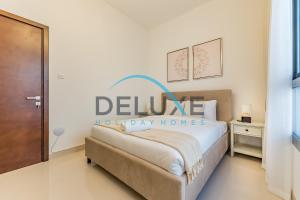 a bedroom with a bed with a welcome sign on it at Special Rate with Temp Controlled Pool, BBQ & Maid's by Deluxe Holiday Homes in Fujairah