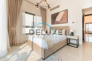 a bedroom with a bed with a sign that reads desire holiday homes at Special Rate with Temp Controlled Pool, BBQ & Maid's by Deluxe Holiday Homes in Fujairah