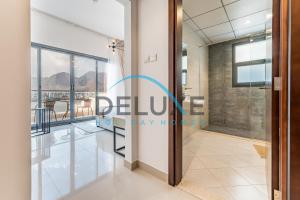 a rendering of the entrance to the lobby of a building at Special Rate with Temp Controlled Pool, BBQ & Maid's by Deluxe Holiday Homes in Fujairah