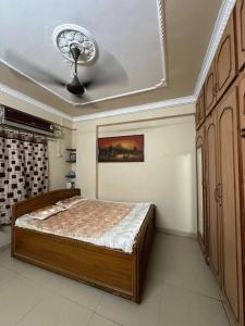 a bedroom with a bed and a ceiling at Talupula oceanic view apartments in Visakhapatnam
