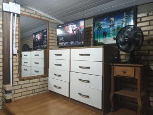 a room with white drawers and a fan at Tiny House Novas Palmeiras in Florianópolis