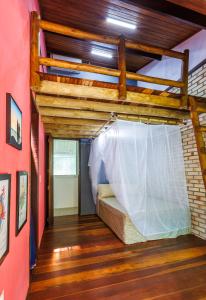 a bedroom with a bed in a room at Casa da Floresta Aruá, Praia do Forte, Bahia in Mata de Sao Joao