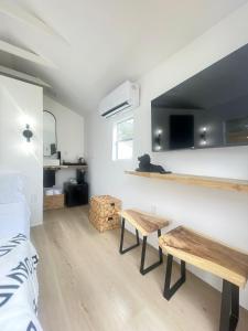 a room with a bed and two benches in it at Charming Coastal Retreat in Miami