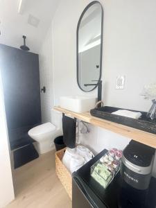 a bathroom with a sink and a mirror at Charming Coastal Retreat in Miami