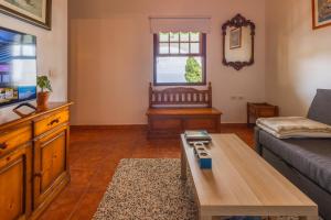 a living room with a couch and a table at Casa de Los Establos - Finca Camacho in Santa Cruz de la Palma