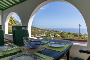 a dining table with a view of the ocean at Casa de Los Establos - Finca Camacho in Santa Cruz de la Palma