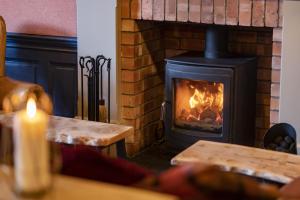 a fireplace with a stove in a living room at Black Bull Hotel in Lauder