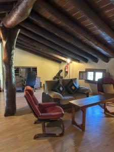 a living room with a couch and a table and a tree at Finca El Corchito Aracena in Aracena +39 photos