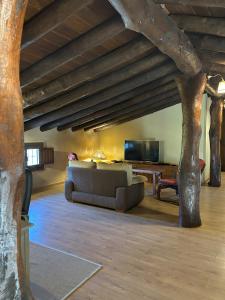 a living room with a couch and a table with a tv at Finca El Corchito Aracena in Aracena +39 photos
