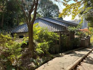a house with a tree in front of it at Chalet 広島 120square japanese one story house 13mins walk from 広島Station in Hiroshima
