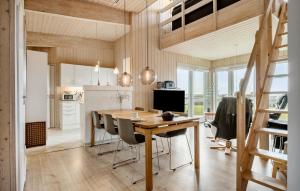 a kitchen and dining room with a wooden table and chairs at Gorgeous Home In Faaborg With Sauna in Bogentved