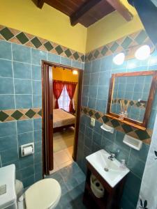 a bathroom with a toilet and a sink and a mirror at El Quincho in Costa del Este