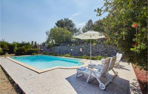 a swimming pool with two chairs and an umbrella at Villa Gioiosa in Caramagna Ligure +19 photos