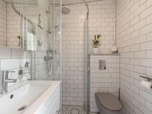 a bathroom with a sink and a toilet and a shower at Furnished bungalow near beach in Sint Maartenszee +27 photos