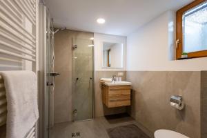 a bathroom with a shower and a sink at Haus Kaufmann in Ellmau +11 photos