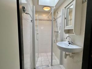 a bathroom with a shower and a sink at Bungalow for 4 people in Wildrijk in Sint Maartenszee