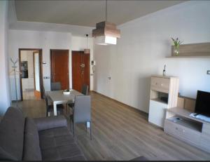 a living room with a couch and a dining room at Casa Serena in Carrara