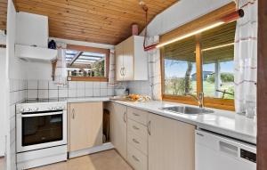 a kitchen with white appliances and a window at Cozy Home In Bogense With Wifi in Bogense