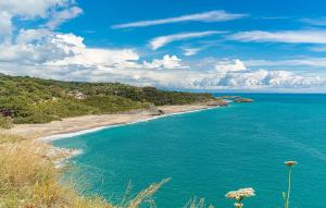 サン・ジョヴァンニ・ア・ピーロにあるAmazing Home In San Giovanni A Piroの青い水と木々が茂るビーチの景色 +19枚の写真