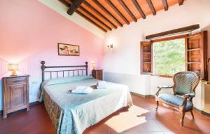 a bedroom with a bed and a chair and a window at 6 Bedroom Amazing Home In Dicomano in Dicomano