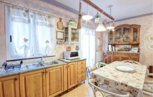 a kitchen with a sink and a table at Piccole Donne in Casarza Ligure