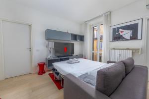 a living room with a couch and a television at Kramer House-Porta Venezia-5min to Duomo in Milan