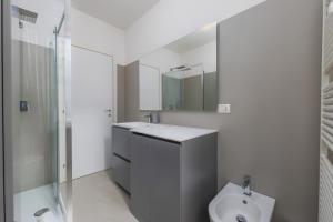 a bathroom with a toilet and a sink and a shower at Kramer House-Porta Venezia-5min to Duomo in Milan +13 photos
