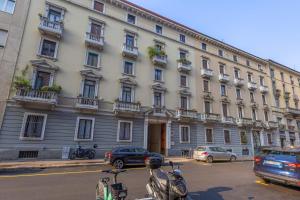 a large building with motorcycles parked in front of it at Kramer House-Porta Venezia-5min to Duomo in Milan
