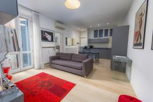 a living room with a couch and a kitchen at Kramer House-Porta Venezia-5min to Duomo in Milan