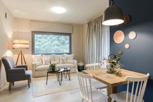 a living room with a table and a couch at Topos Villas in Parga