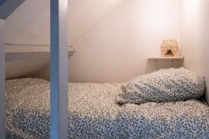 a bedroom with a bed with a pillow on it at Le cocon de la gare in Rennes