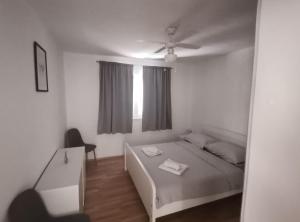 a white bedroom with a bed and a window at Perfect Getaway Near Korčula’s Scenic Sights and Beaches in Žrnovo +8 photos