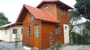 a small wooden house with an orange roof at Tiny House Novas Palmeiras in Florianópolis