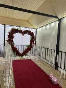 a room with a red carpet and a heart decoration at Close to the sky in Agara