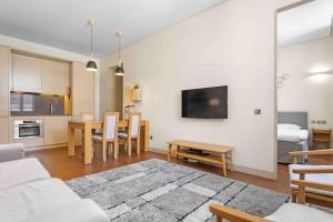 a living room with a couch and a table at The João I Collection Two Bedroom in Lisbon