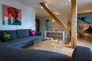 a living room with a couch and a table at Le Majestic 145 Apartment - Chamonix All Year in Chamonix-Mont-Blanc