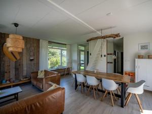 a living room with a table and a couch at Holiday home in Petten with garden in Petten