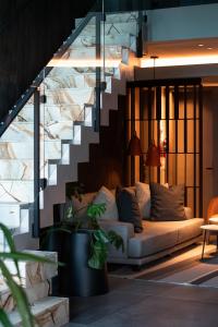 a living room with a couch under a staircase at EHBoutique Experience in El Calafate