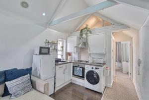 a kitchen with a washer and dryer in a room at Host & Stay - Sail Loft in Hayle