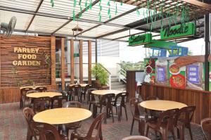 a restaurant with tables and chairs in a room at Salim Inn in Sibu