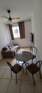 a living room with a table and chairs and a couch at Encontre seu lar perfeito in Barretos